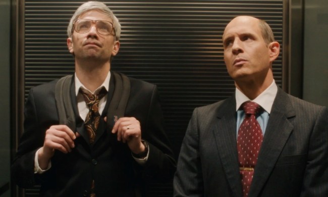 Two men stand in an elevator in BlackBerry.