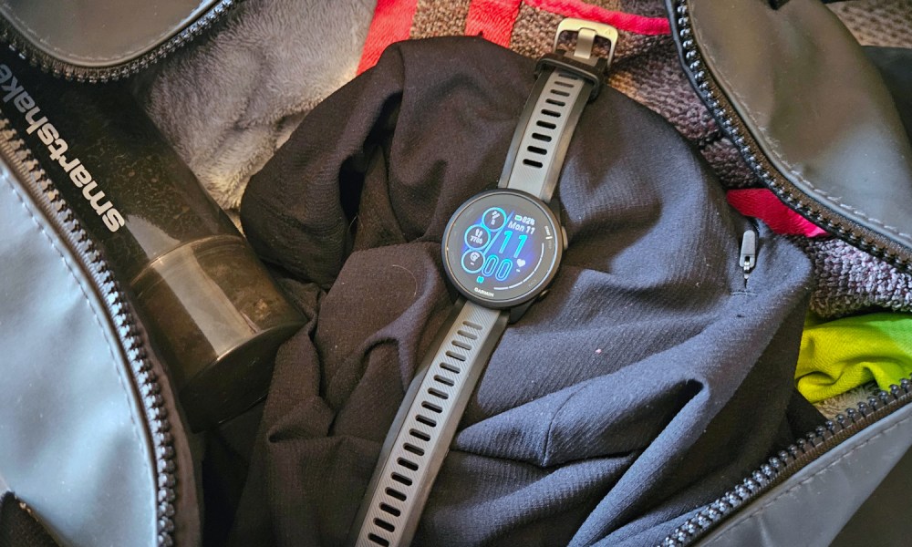 The Garmin Forerunner 165 Music sat in an open gym bag.