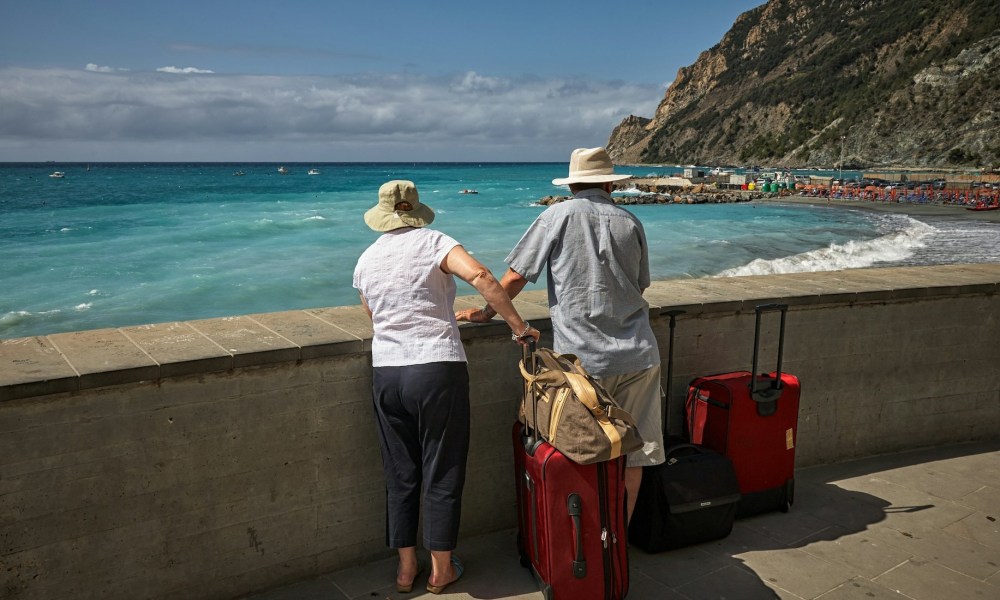 Older couple looking at beautiful coastal views while traveling.