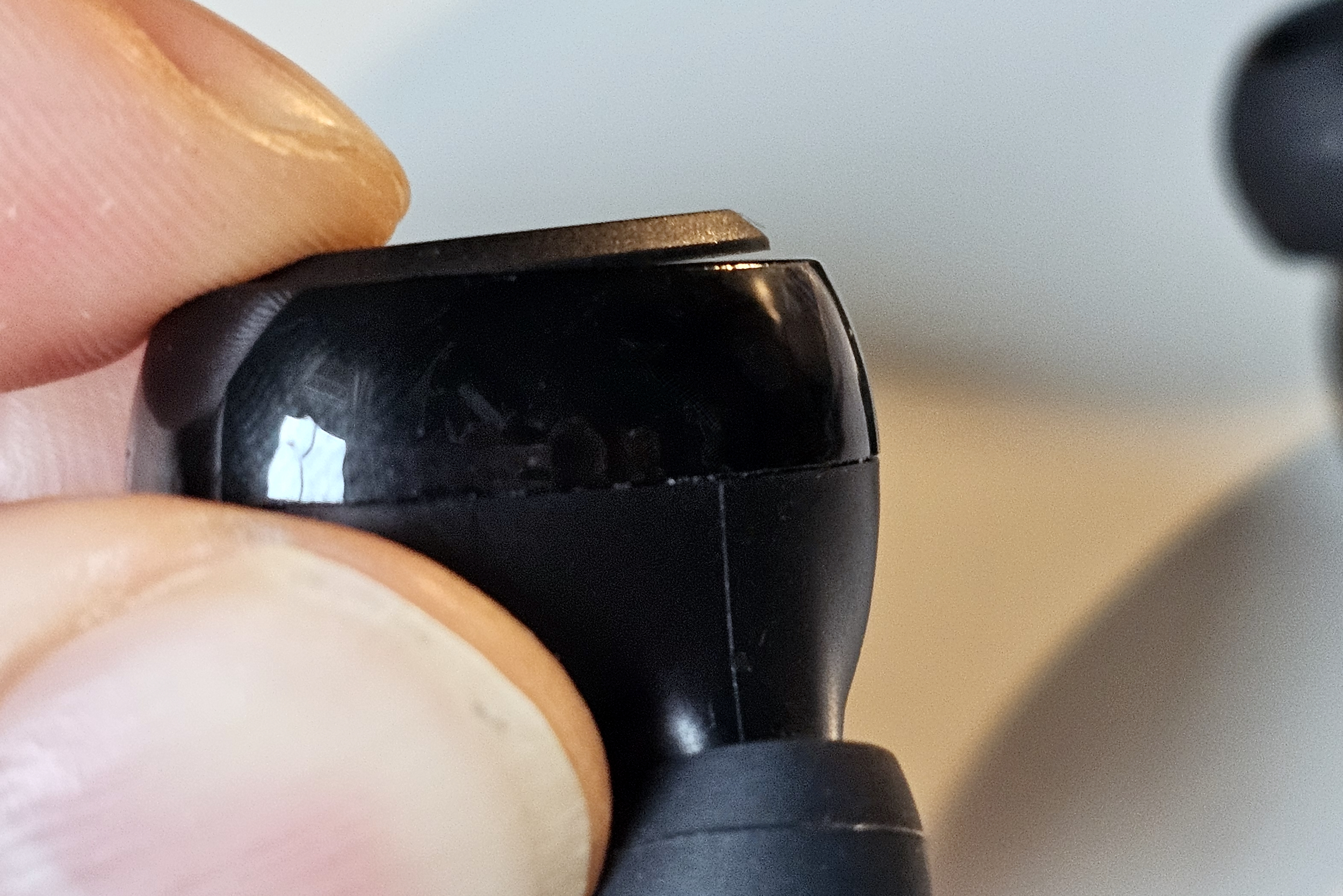 Close up of PSB Speakers M4U TWM earbud showing the gap created when pressing the control button.