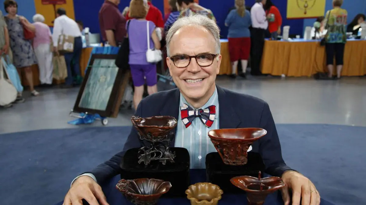 Lark Mason poses with collectibles on Antiques Roadshow.