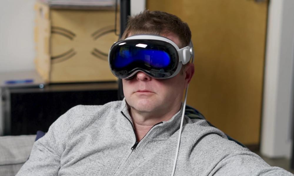 A man wears an Apple Vision Pro headset.