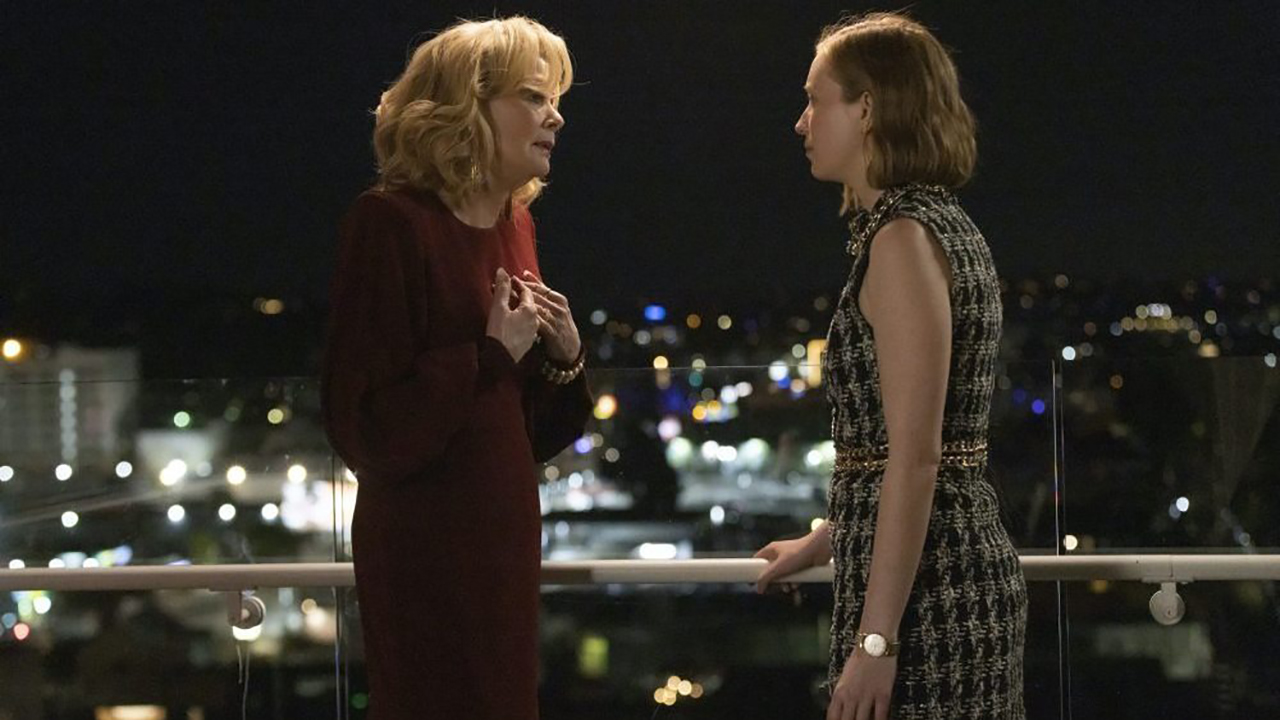 Deborah and Ava in Hacks standing on a balcony talking in a scene from season 3 of Hacks.