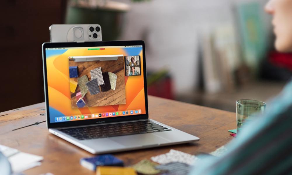 An iPhone being used on a MacBook as a webcam thanks to Apple's Continuity Camera feature in macOS Ventura.