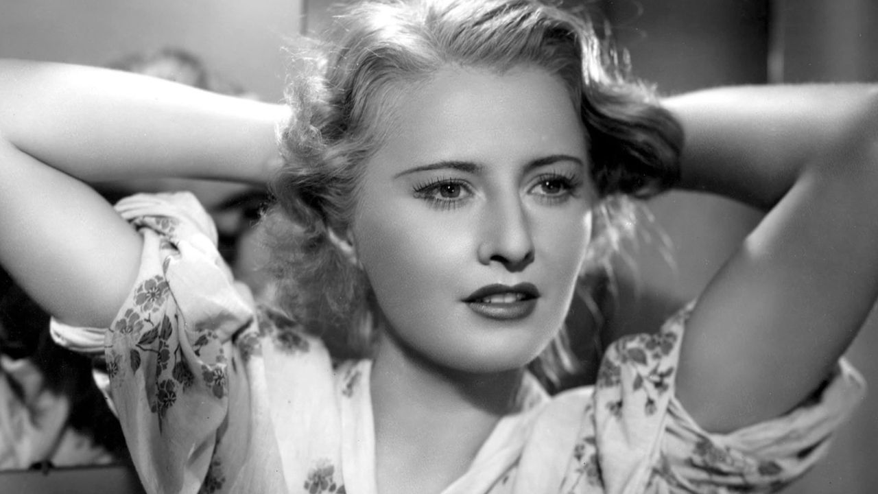 Barbara Stanwyck as Stella Dallas pulling her hair up in Stella Dallas.