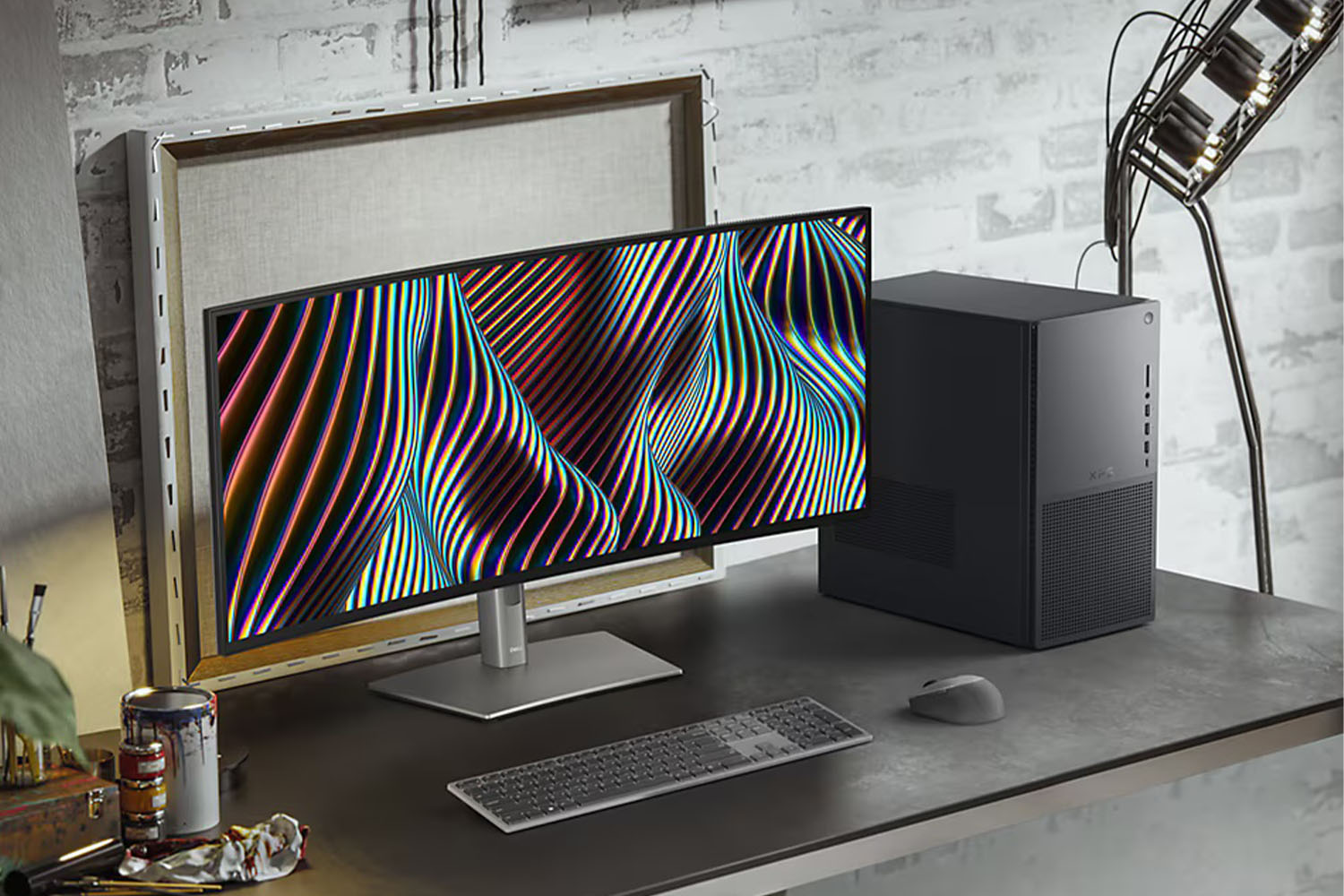 The Dell XPS Desktop on a desk next to a monitor.