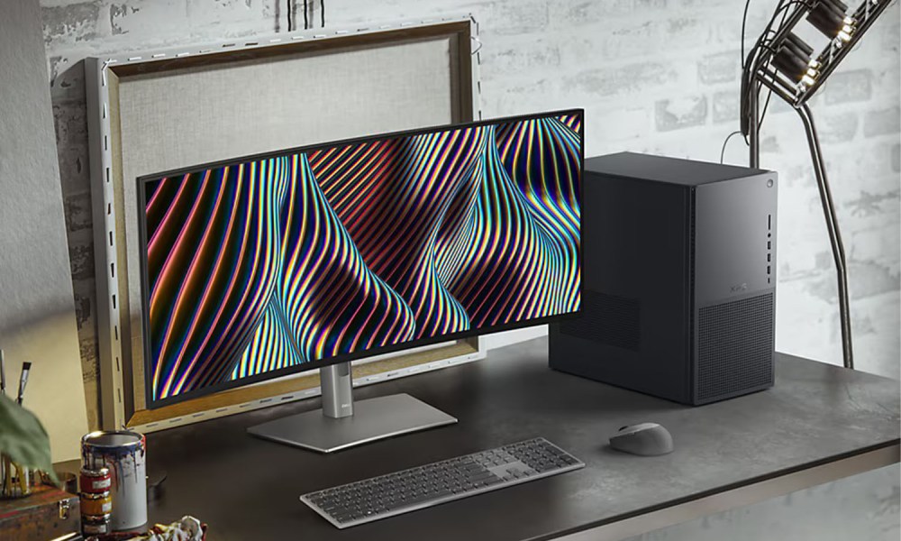 The Dell XPS Desktop on a desk next to a monitor.