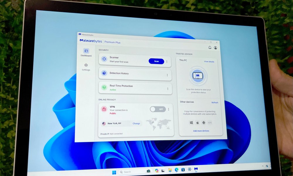 Malwarebytes user interface appears on a Microsoft Surface Book.