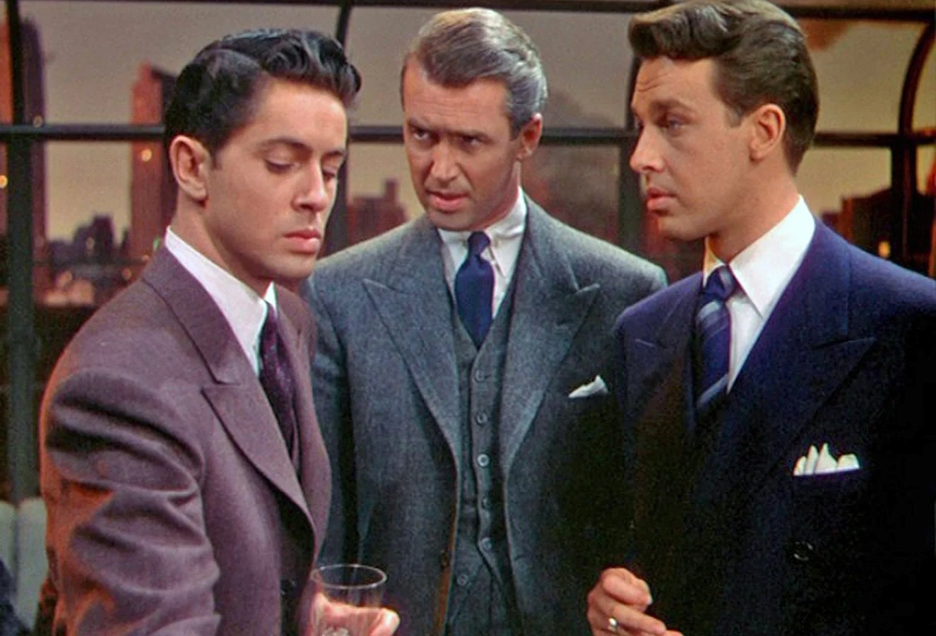 Three men stand and talk in Hitchcock's Rope.