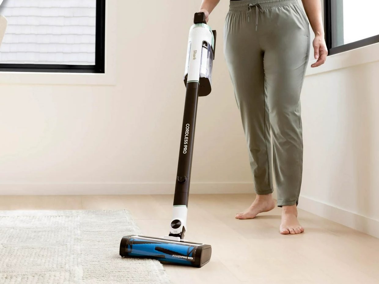 The Shark Cordless Pro Stick Vacuum being utilized connected some carpet and difficult wood flooring.