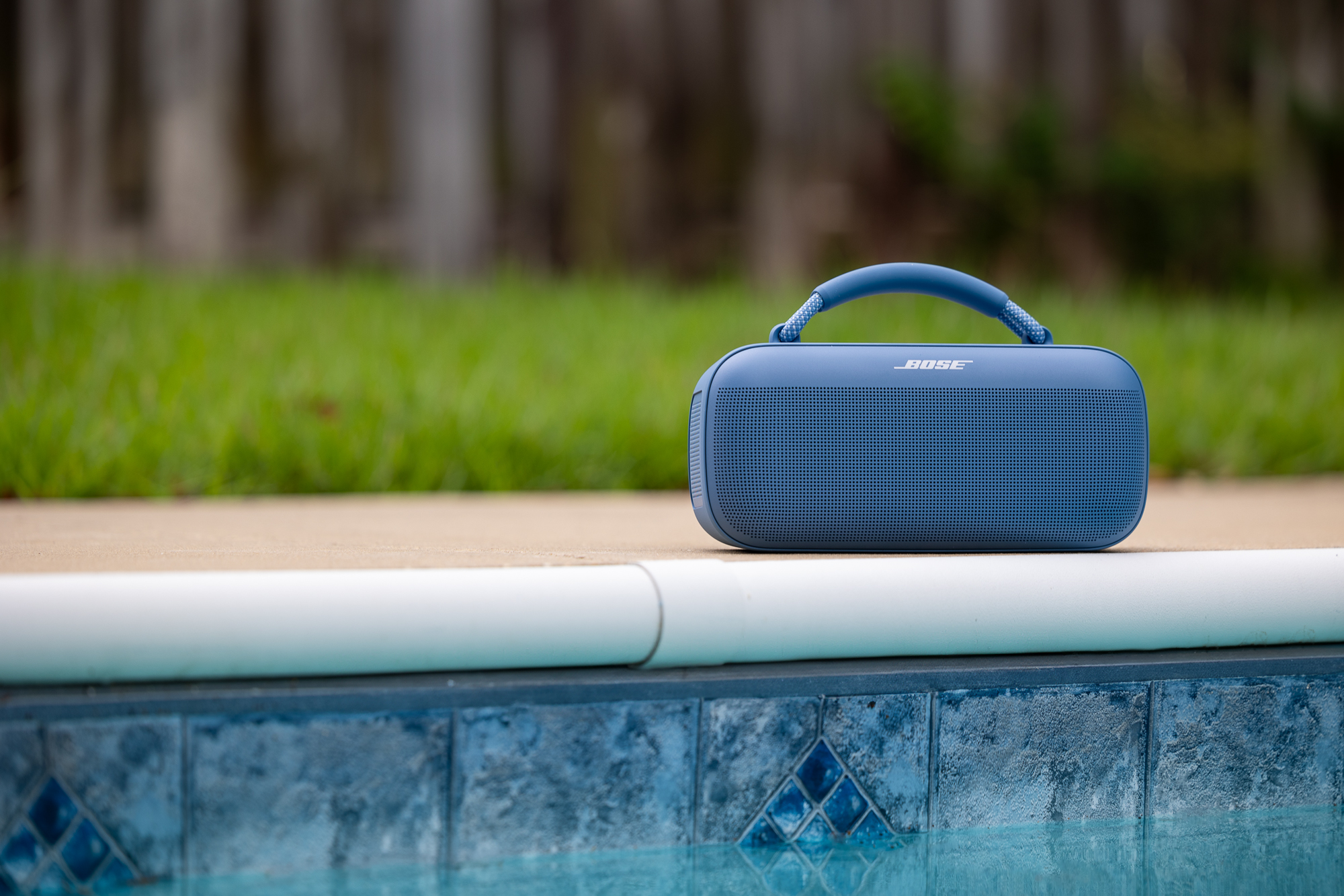 The Bose SoundLink Max Bluetooth speaker alongside a pool.