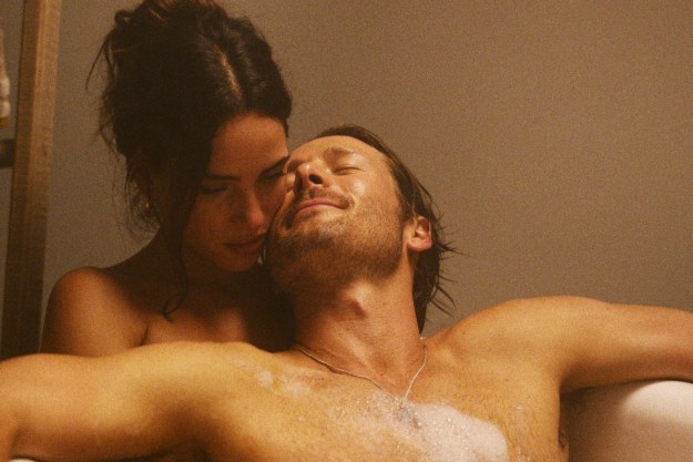 A man and a woman soak in a bathtub in Hit Man.