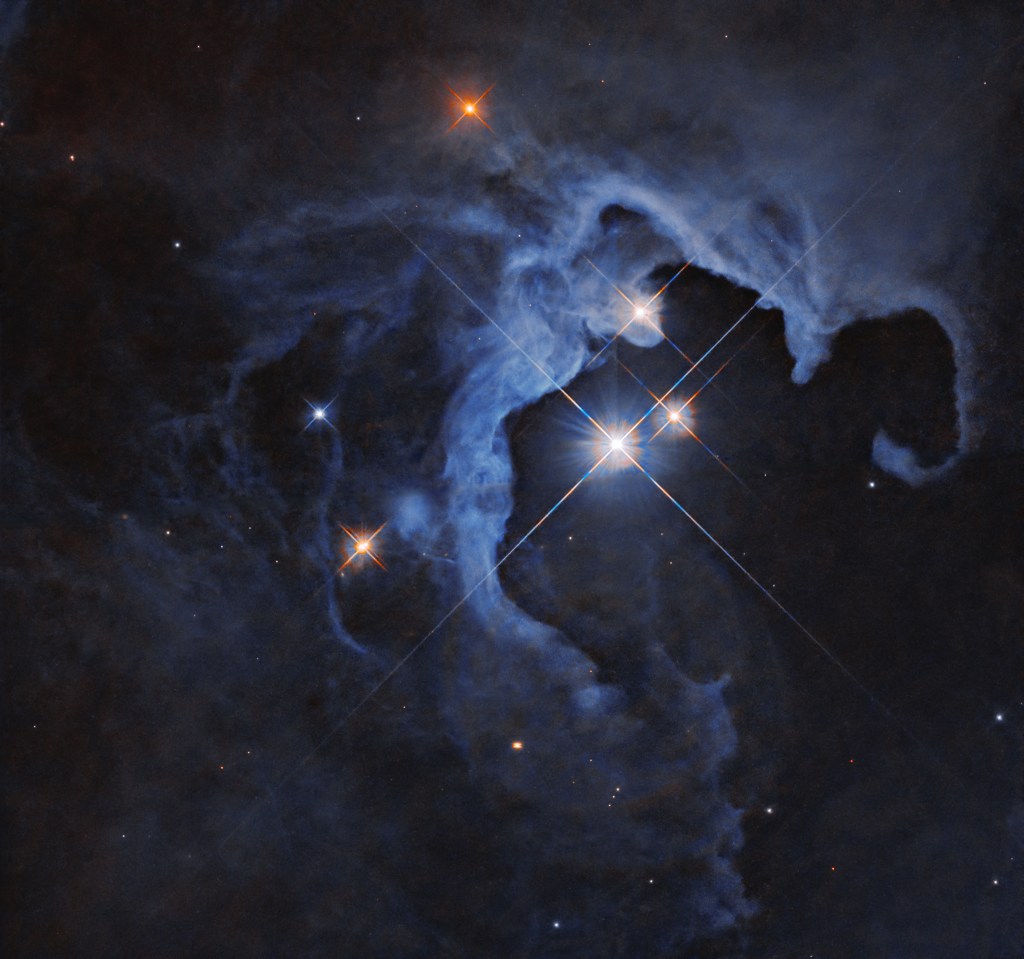 This NASA Hubble Space Telescope image captures a triple-star star system.