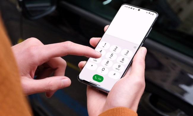 A person making a phone call on a Samsung Galaxy S24 in a car.