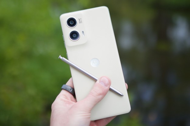 Someone holding the Moto G Stylus 5G (2024), showing the back of the phone and its stylus.