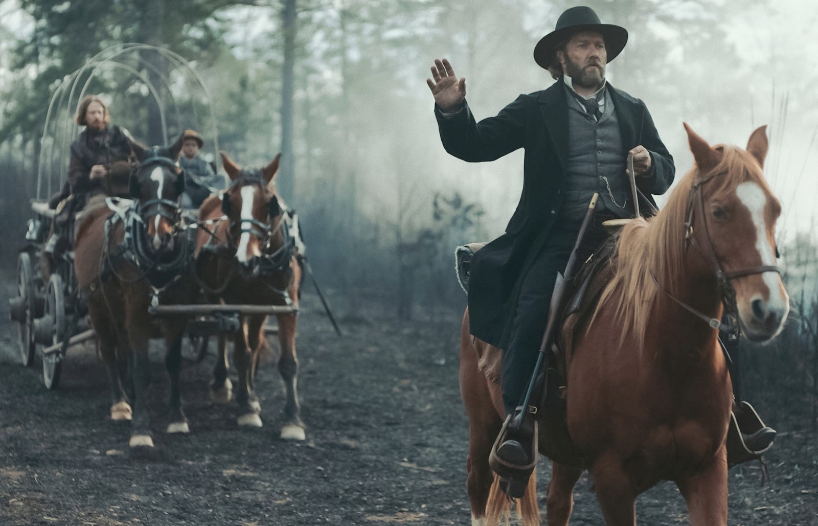 A man riding a horse raises his arm in The Underground Railroad.