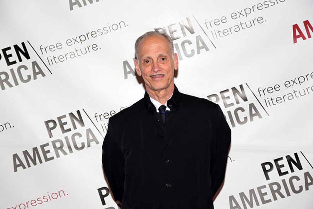 John Waters poses at an event.
