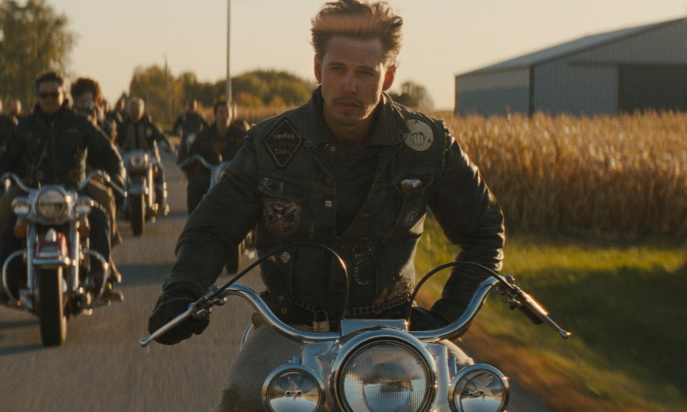 Austin Butler drives alongside a motorcycle gang in The Bikeriders.