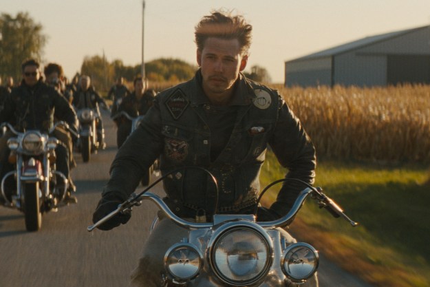Austin Butler drives alongside a motorcycle gang in The Bikeriders.