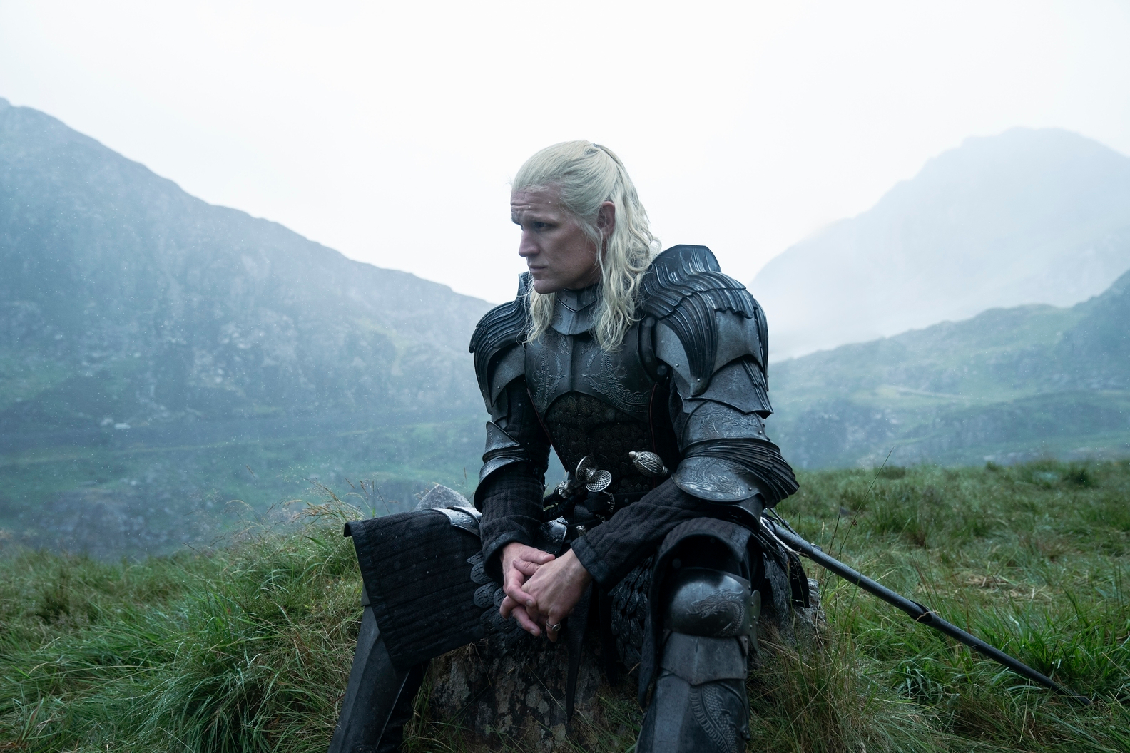 Daemon Targaryen se sienta solo en un campo en la temporada 2 de House of the Dragon.