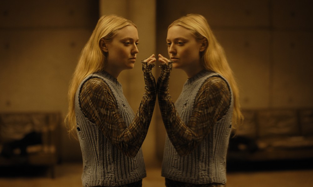 Dakota Fanning stands in front of a mirror in The Watchers.