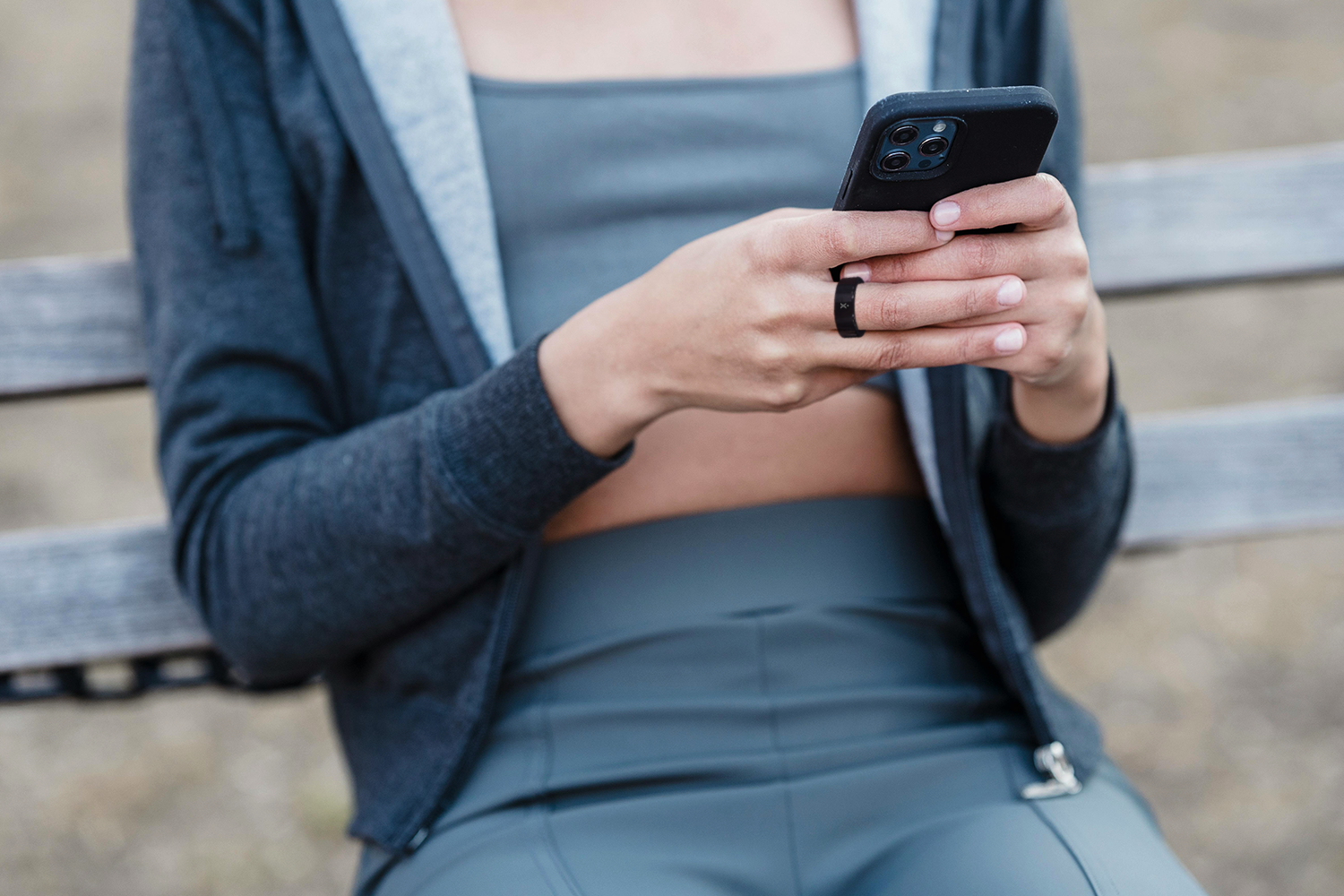 A promotional image showing someone wearing the ExerRing smart ring.