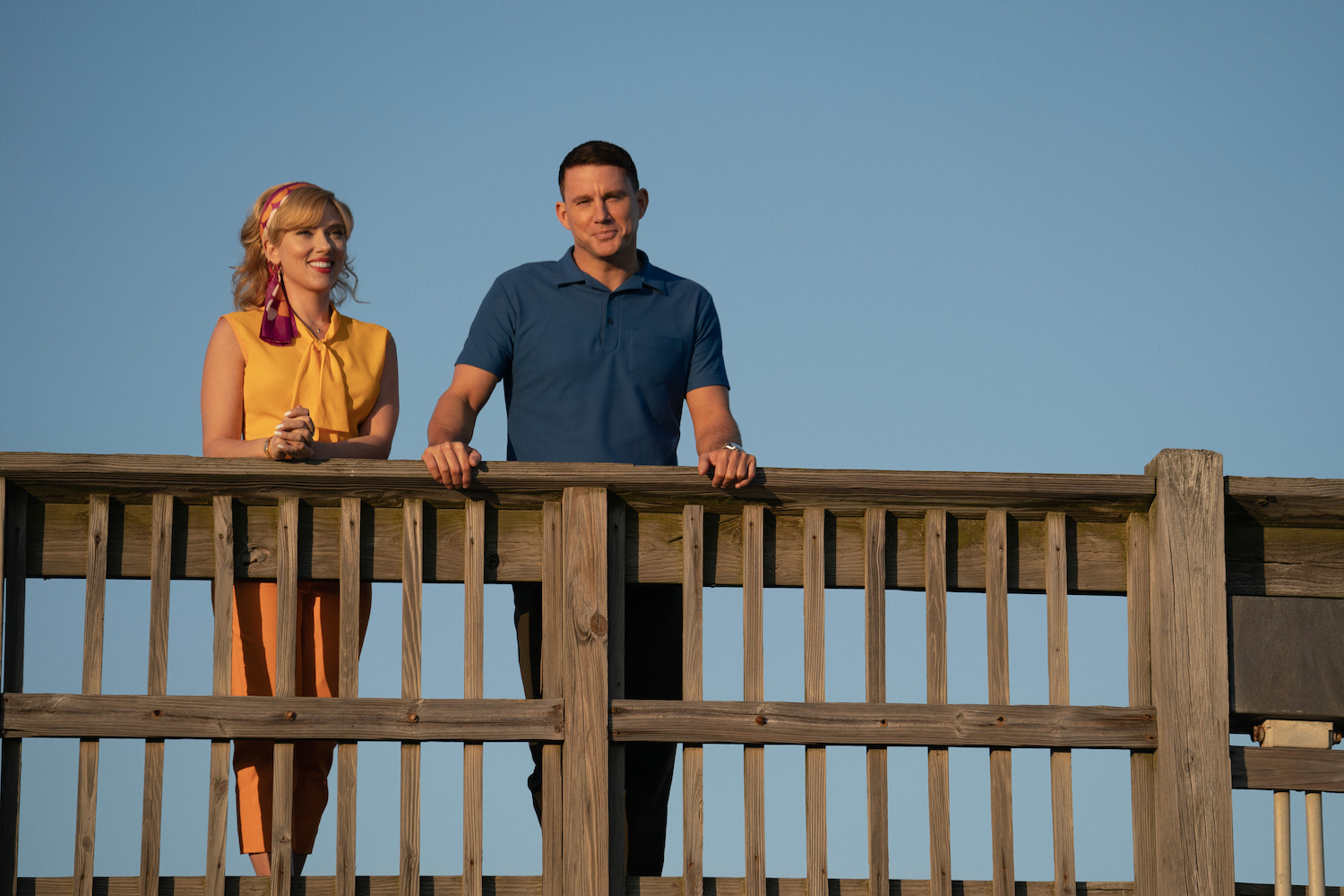 Scarlett Johansson stands next to Channing Tatum on a deck.