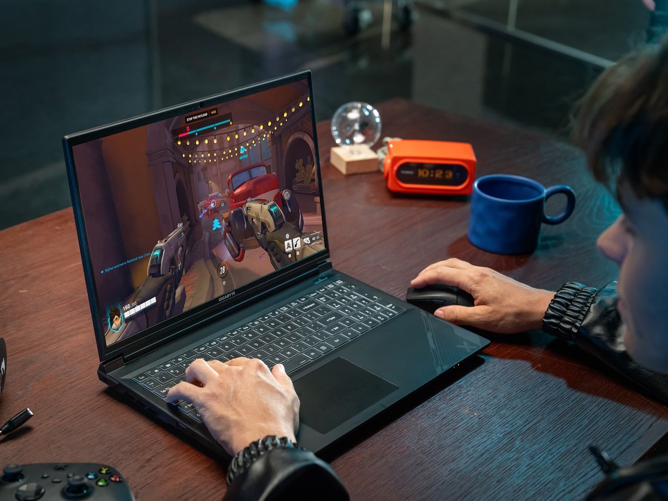 Gamer playing Overwatch on GIGABYTE G6X gaming laptop from GIGABYTE gaming laptop deals.