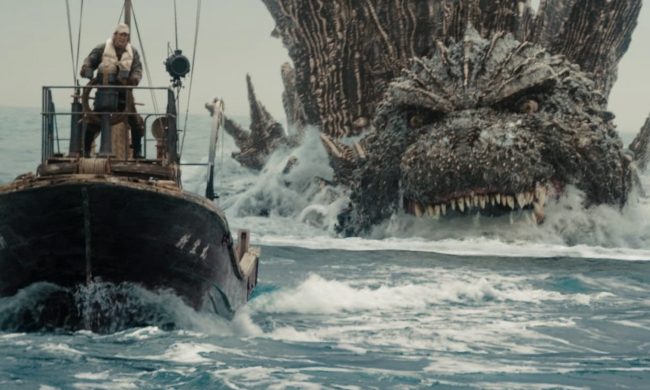 Godzilla swims behind a boat as he readies for attack.