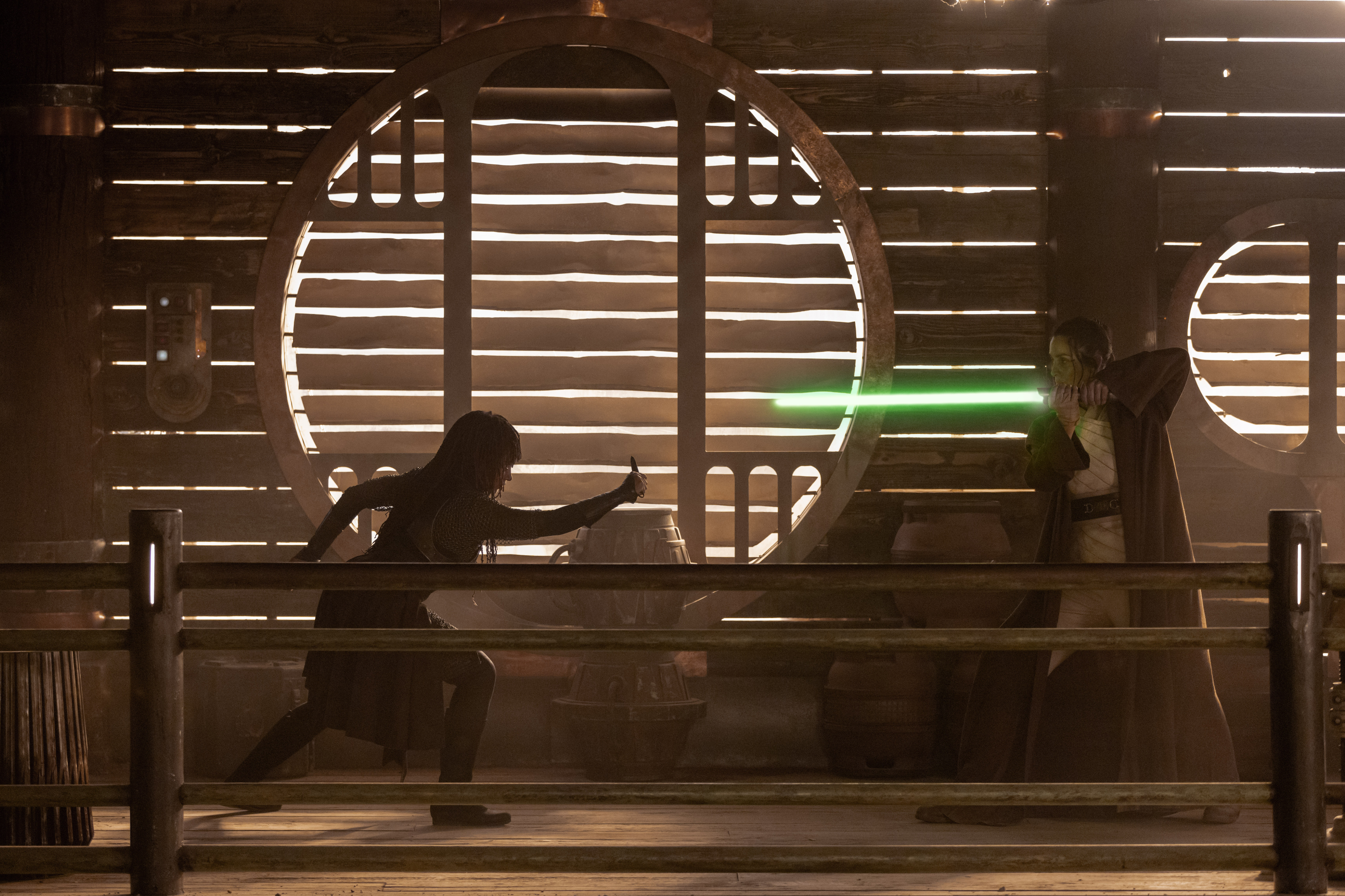 Master Indara points her green lightsaber at Mae in The Acolyte.