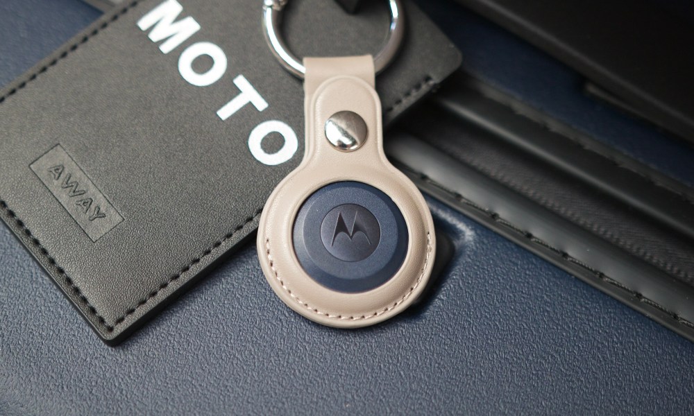 The Moto Tag attached to a suitcase.