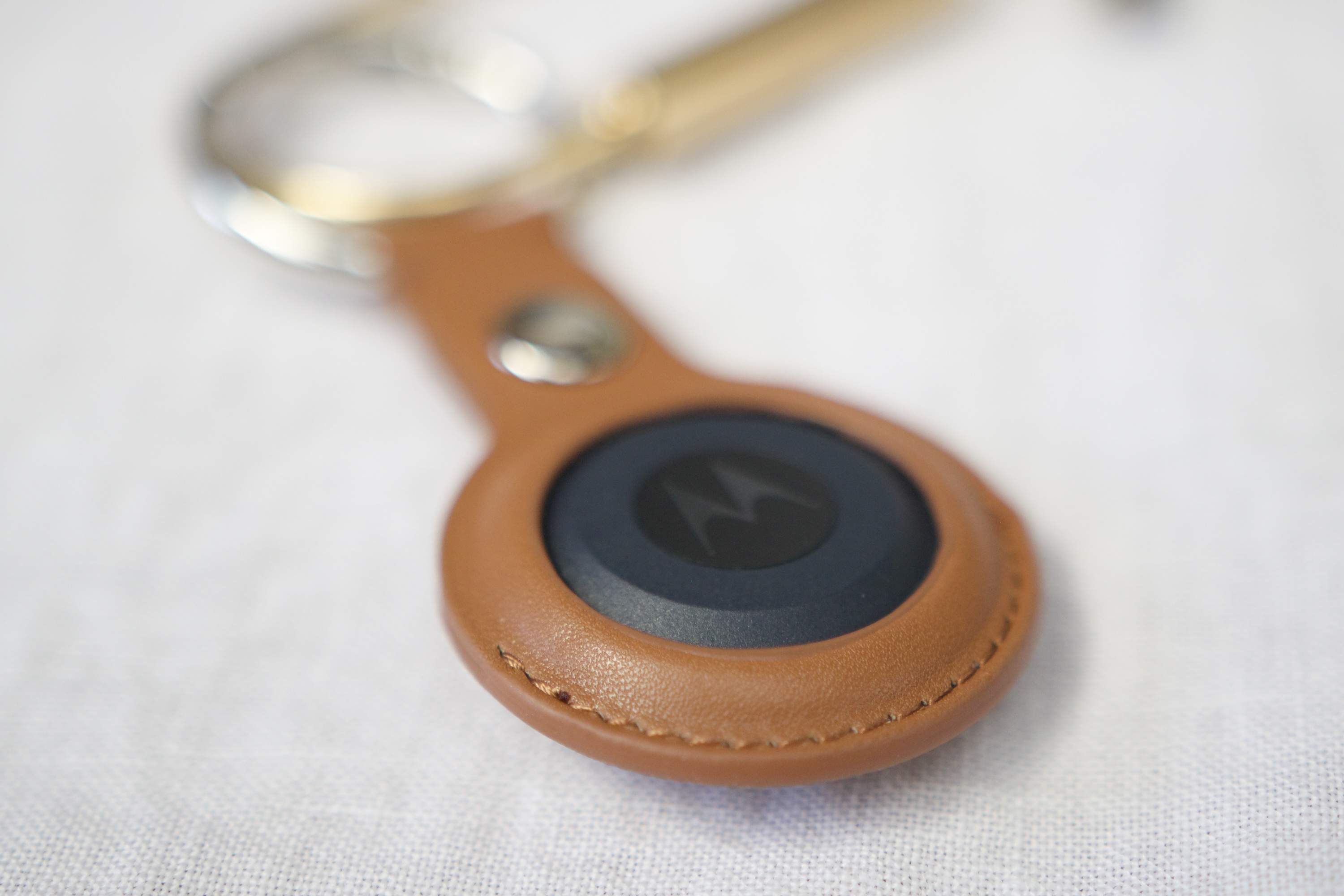 A close-up of the leather keychain case for the Moto Tag.