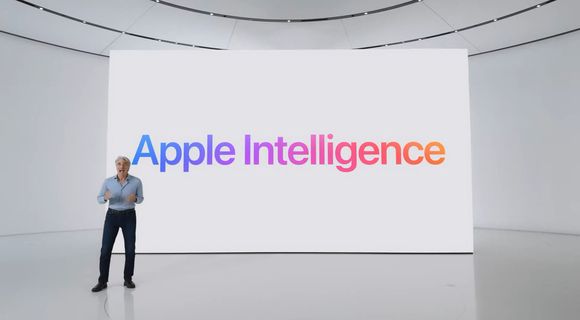 Craig in front of a screen with the words Apple Intelligence written on it