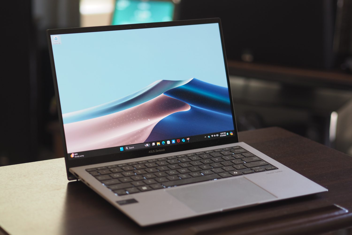 Asus Zenbook S 13 OLED front angled view showing keyboard and touchpad.