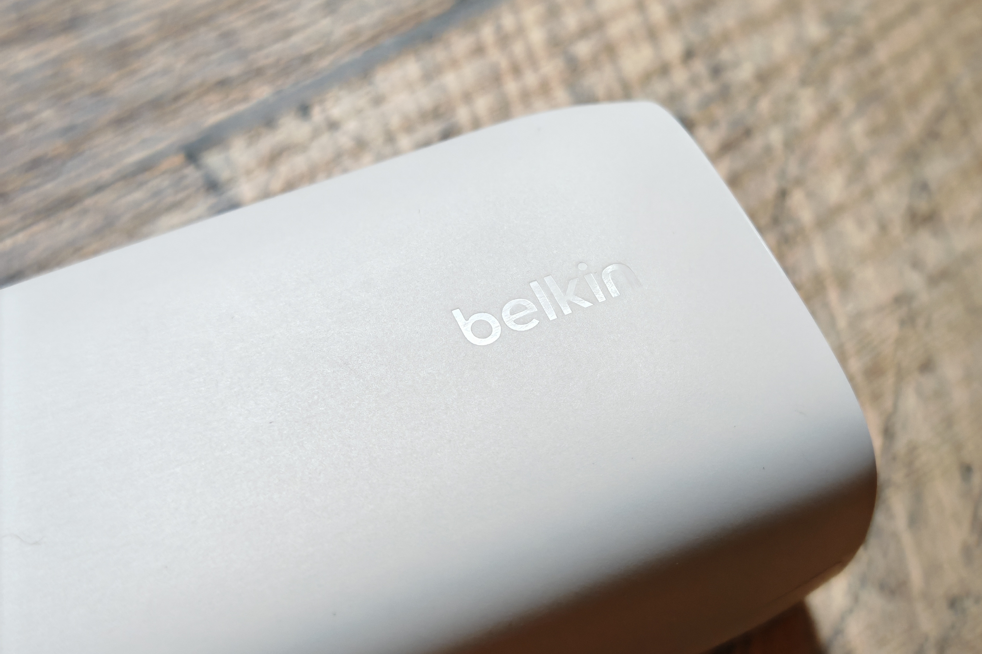 The Belkin logo on a white charger.