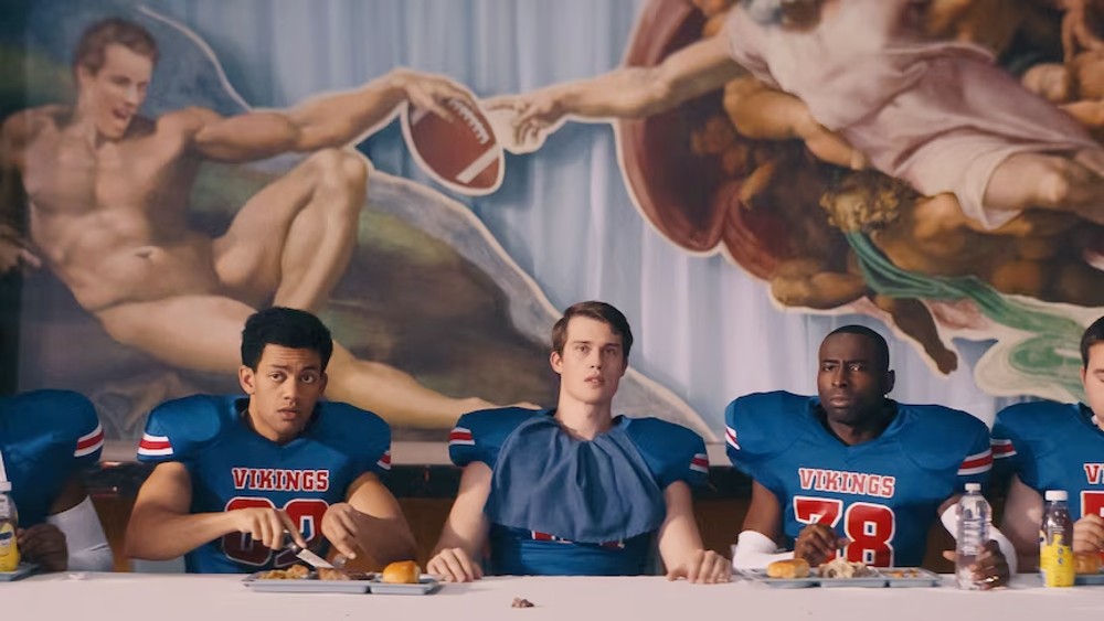 5 football players sit at a table in Bottoms.