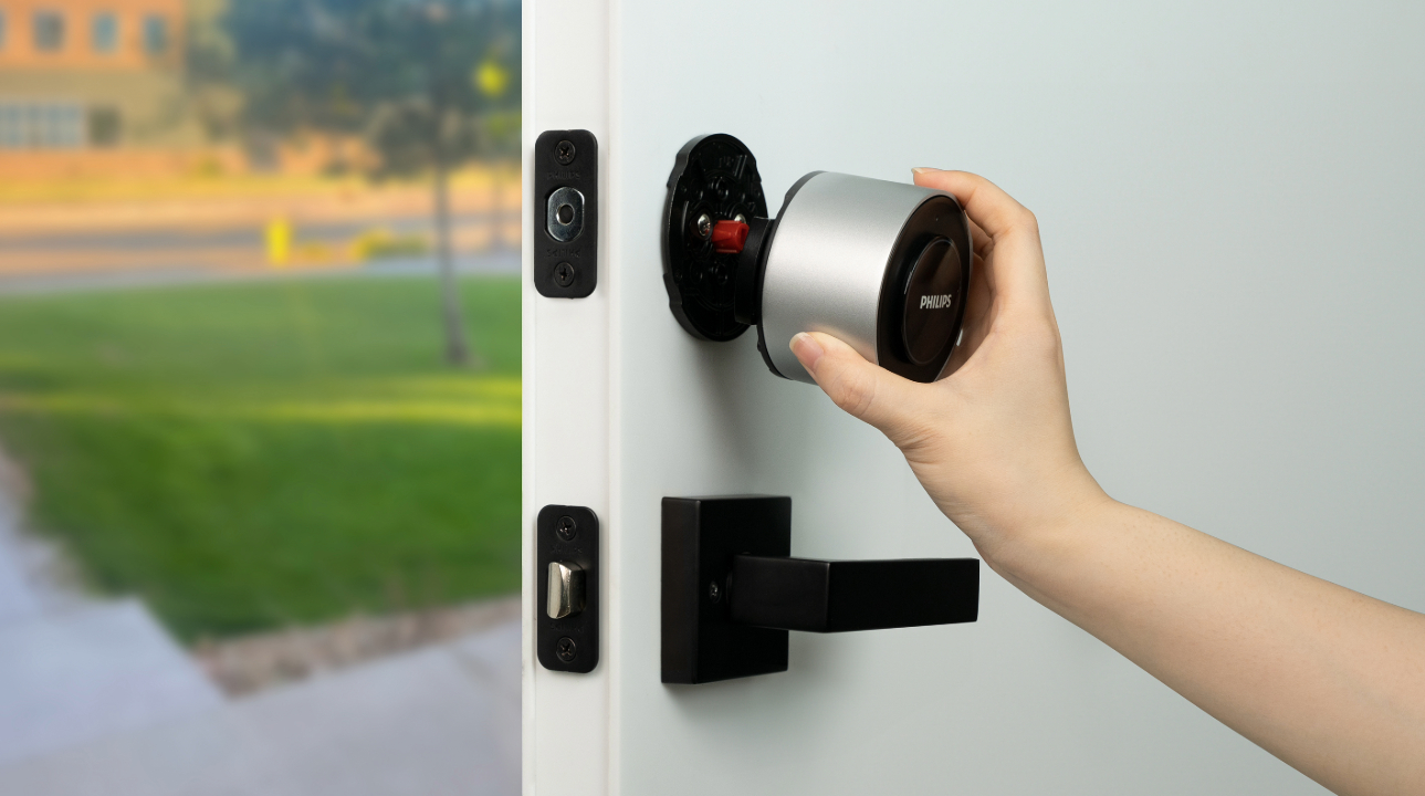 The Philips Smart Deadbolt with Built-In Wi-Fi being installed on a door.