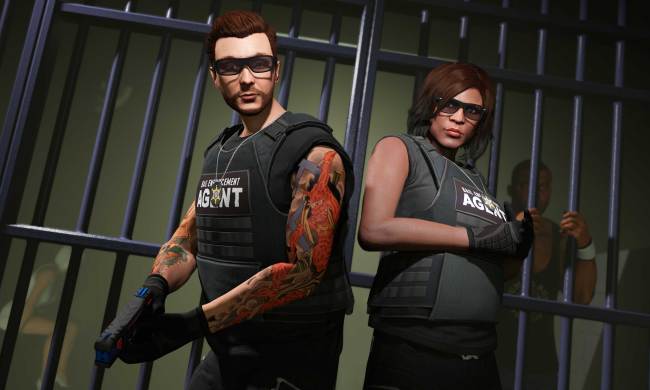 Two GTA Online characters in body armor standing in front of a jail cell with a person in it.