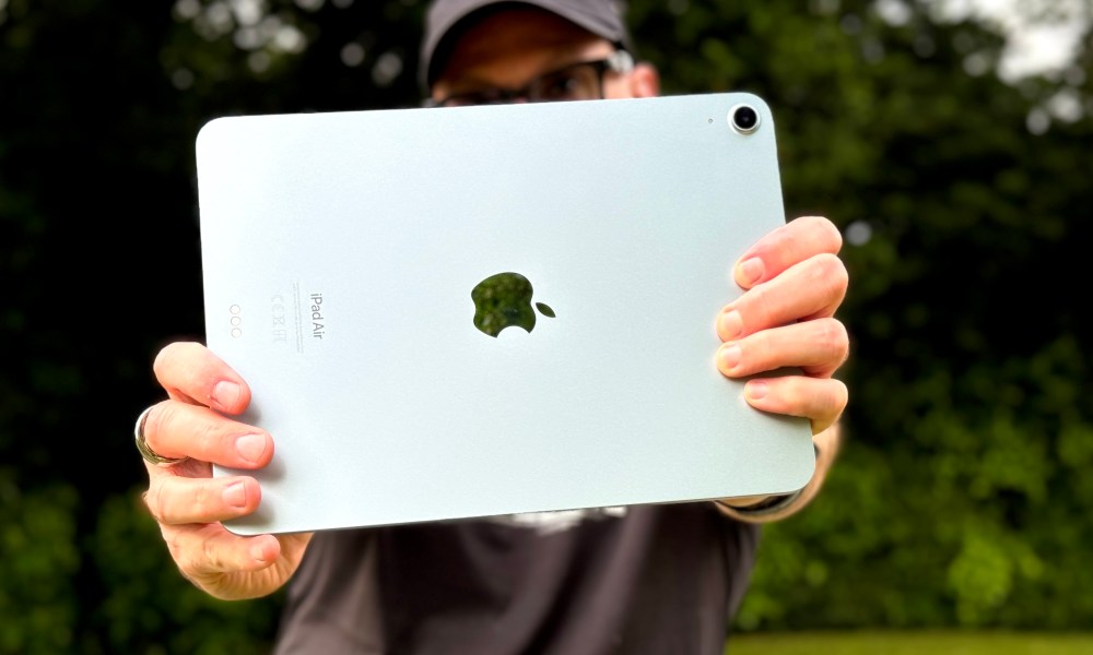 A person holding the iPad Air (2024) and taking a photo.