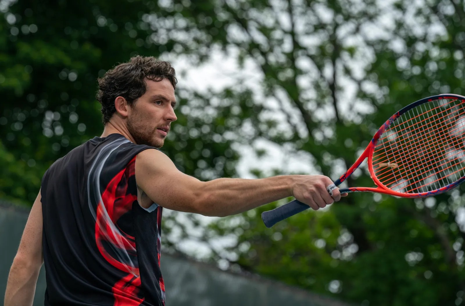 A man holds a racket in Challengers.
