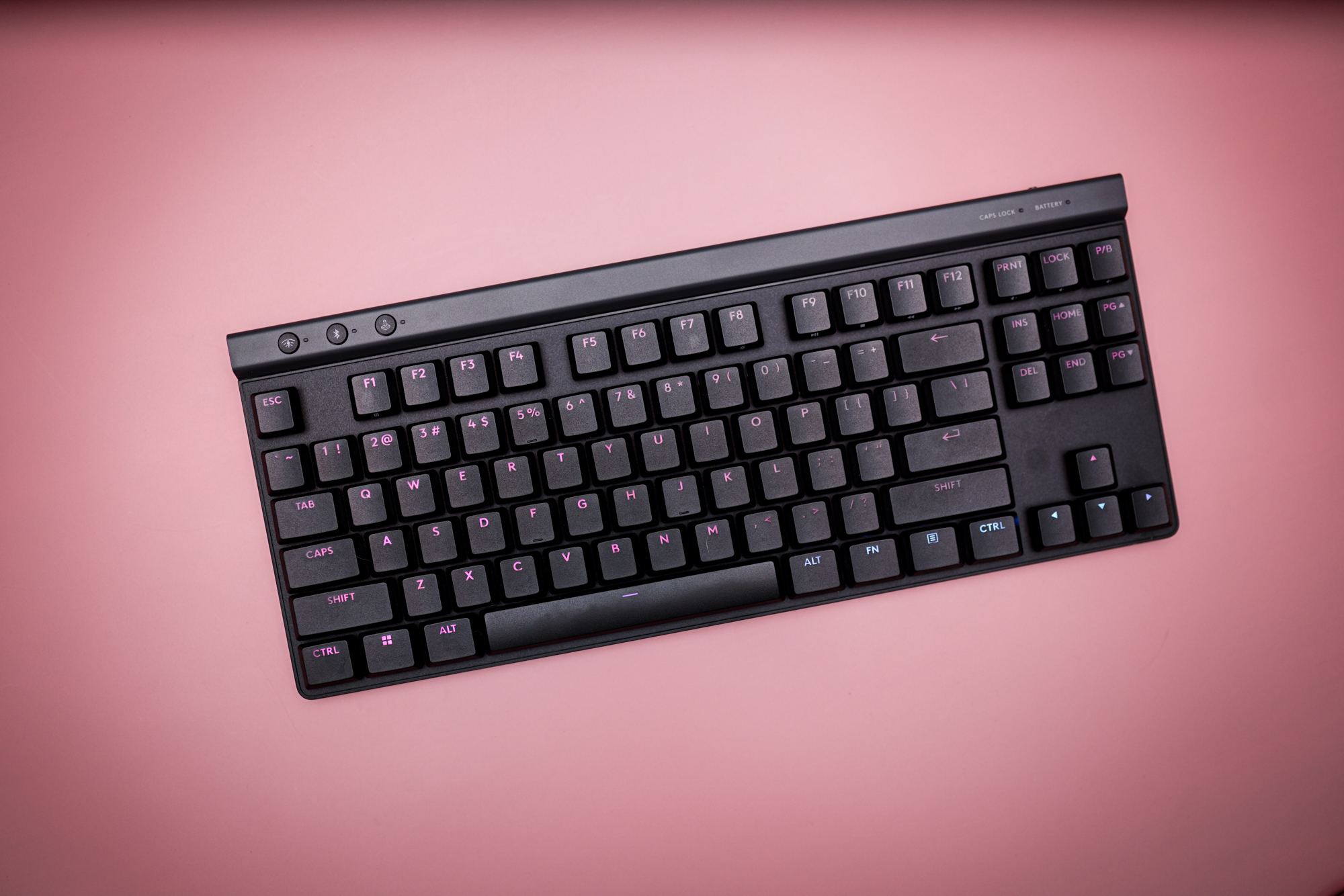 The Logitech G515 keyboard on a pink background.