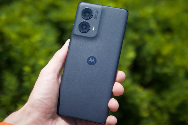 Someone holding the Motorola Edge (2024) outside, showing its leather back.