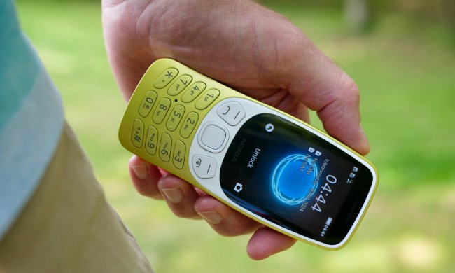 A person holding the Nokia 3210, showing the screen.