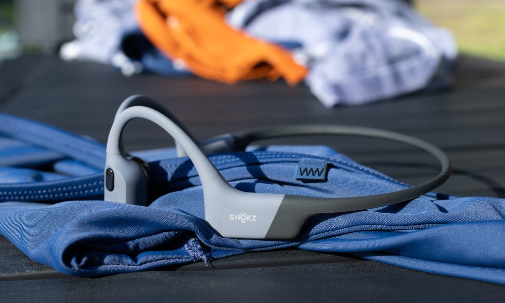 The Shokz OpenSwim Pro next to swimsuits.