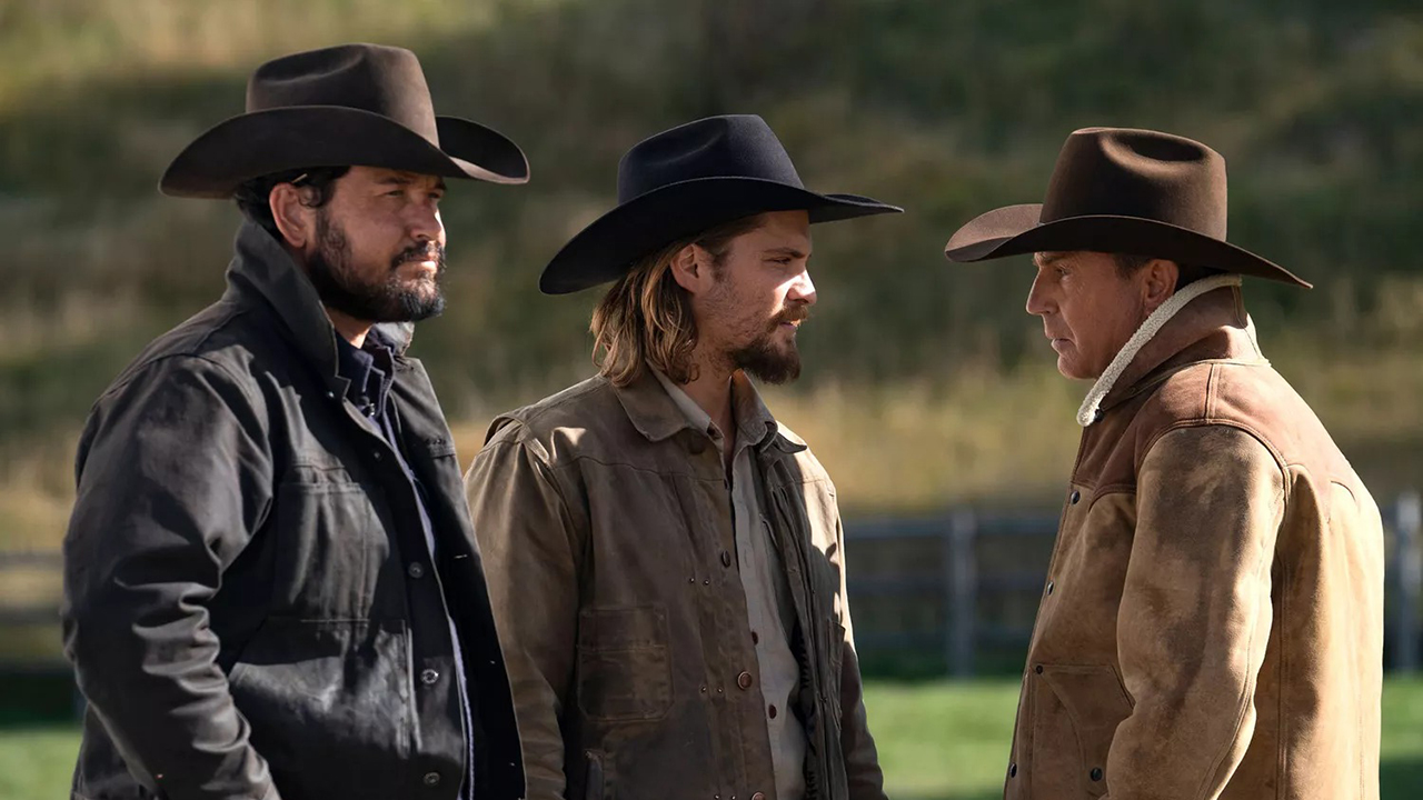 Three men talking outside, each in cowboy hats in a segment from Yellowstone.