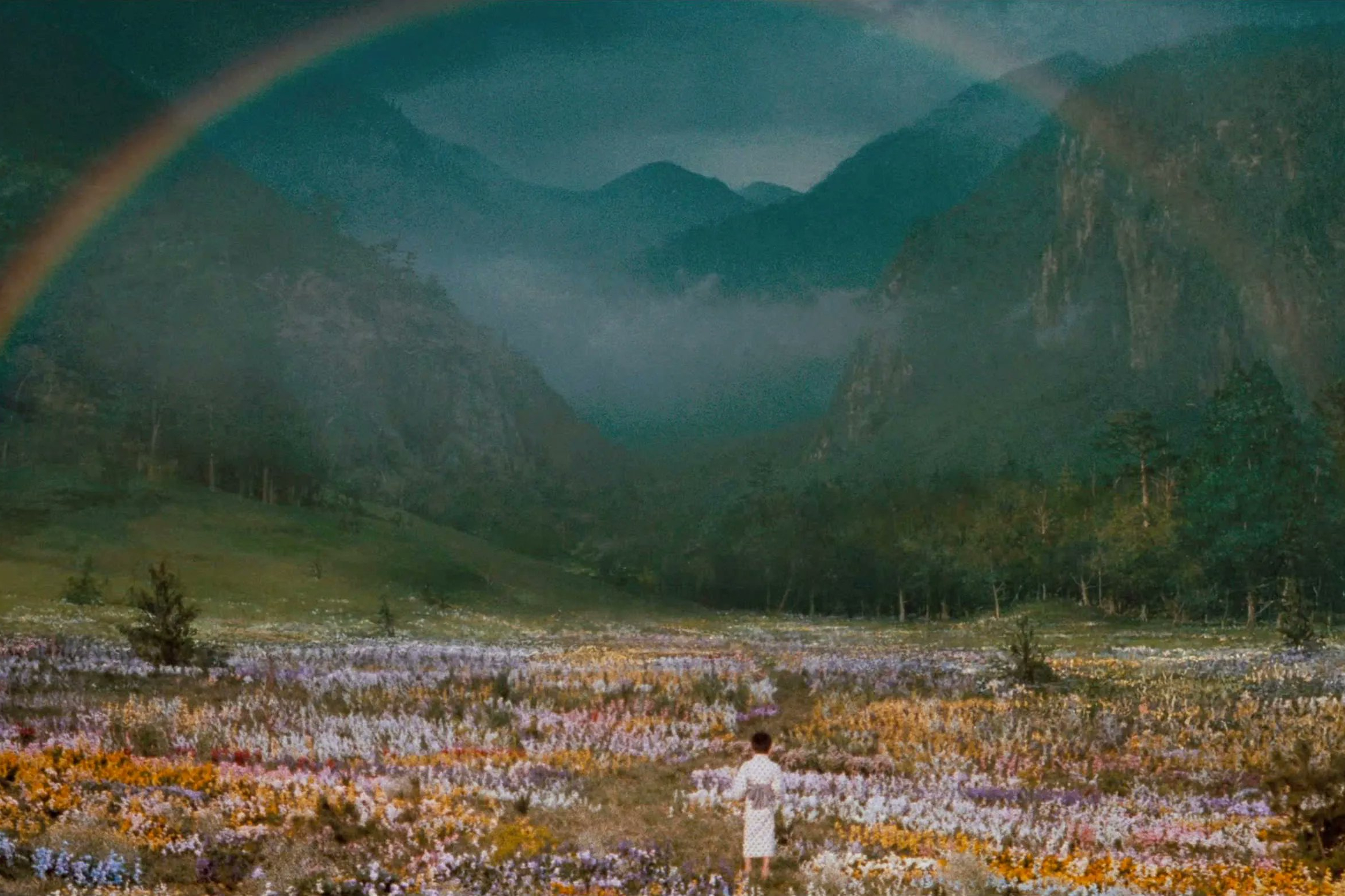 A young boy walks toward a rainbow in Dreams.