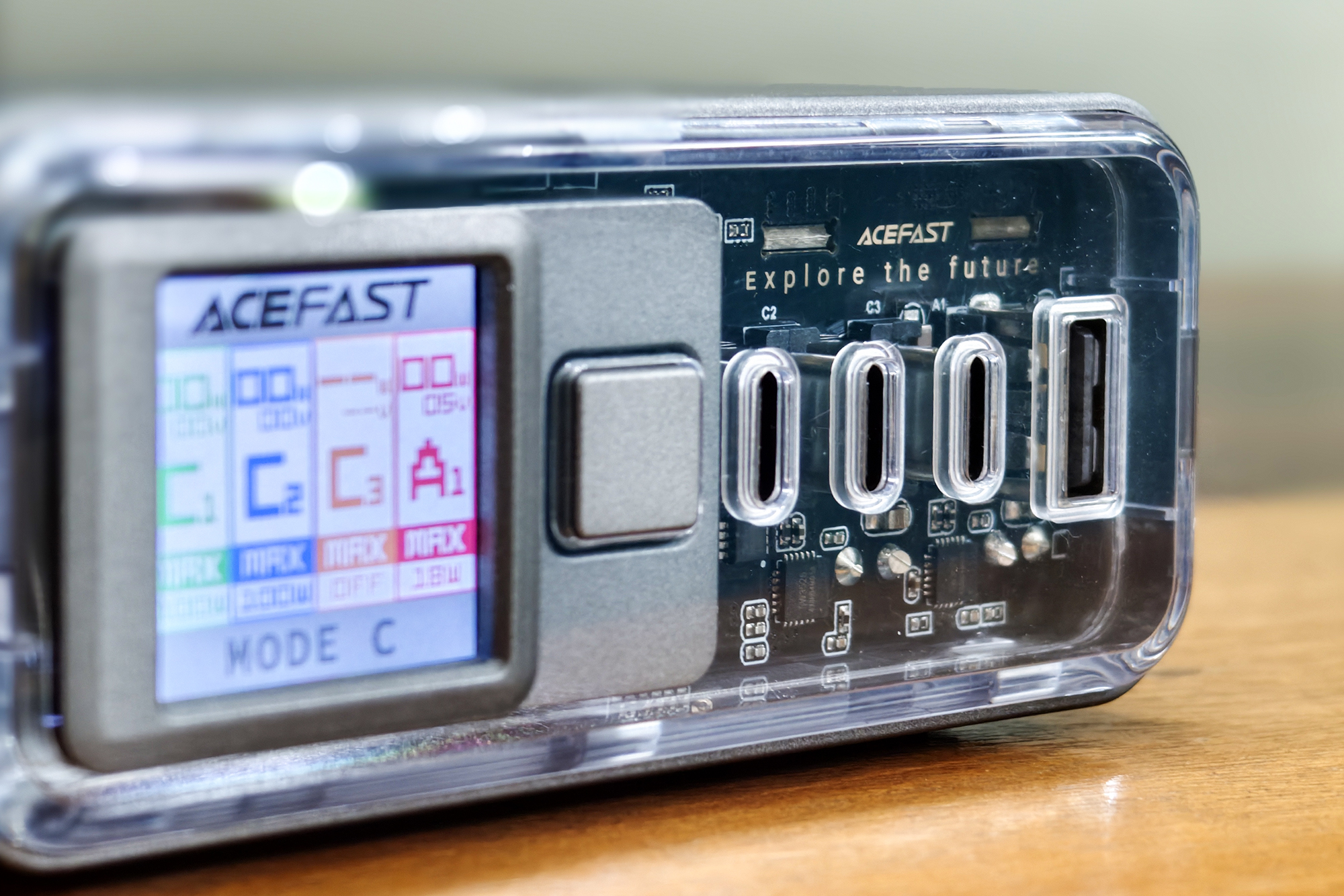 Acefast Z4 218W fast charger with display and transparent front panel kept on a wooden surface.