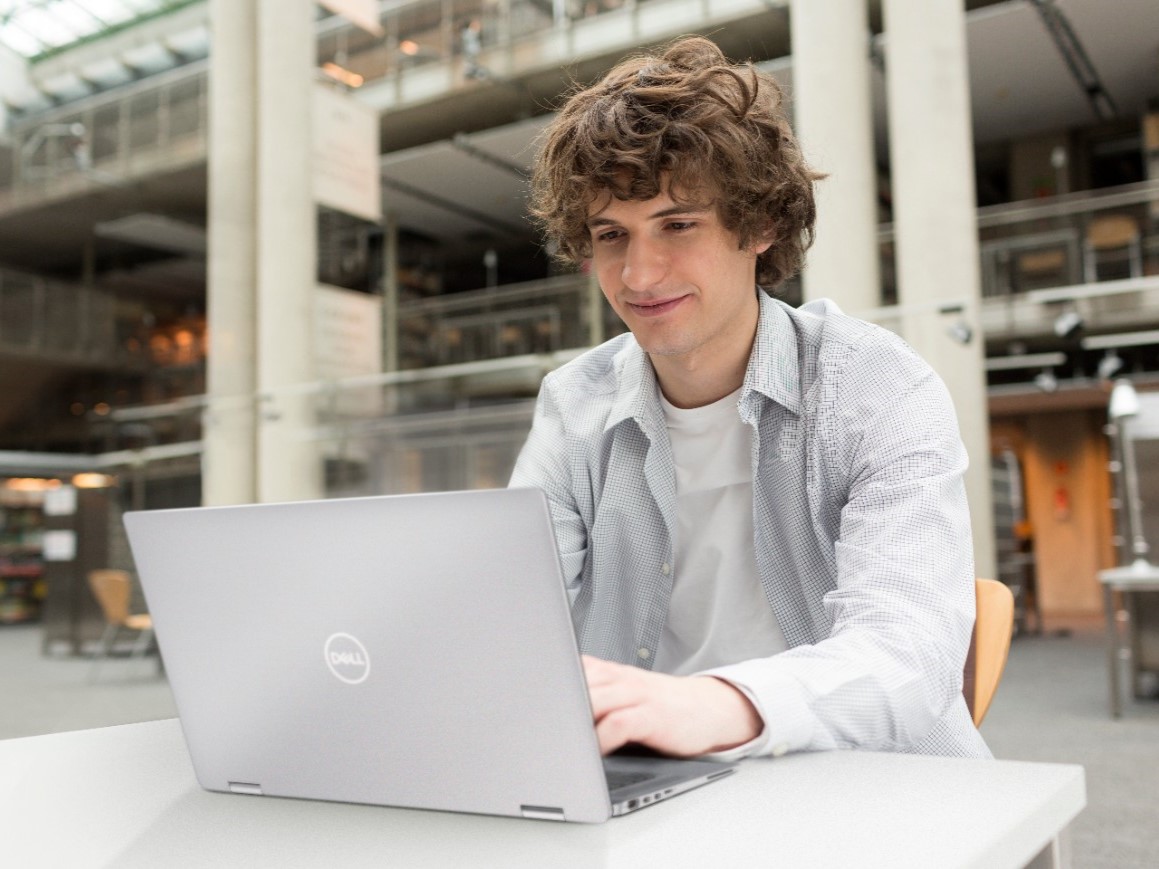 Dell's top PC deals featured image with student on laptop outside