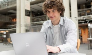 Dell's top PC deals featured image with student on laptop outside