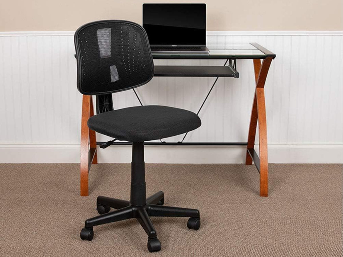 The Flash Furniture Flash Fundamentals Mid-Back Swivel Task Office Chair at a desk.